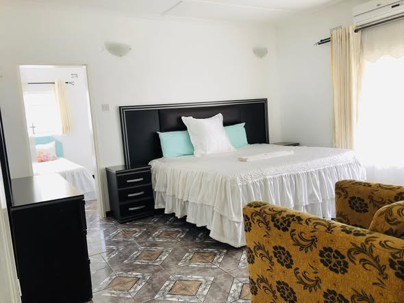 Spacious bedroom with mint green pillows